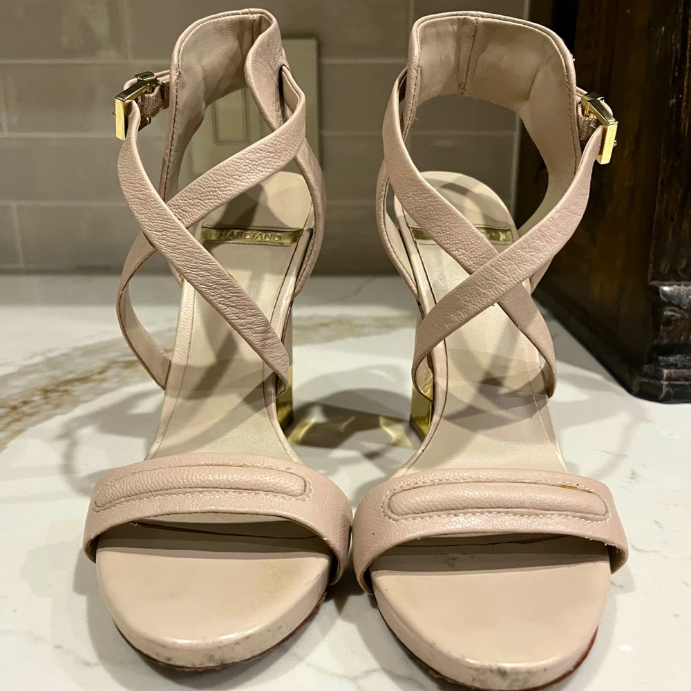 High heel sandals with gold tipped heels.